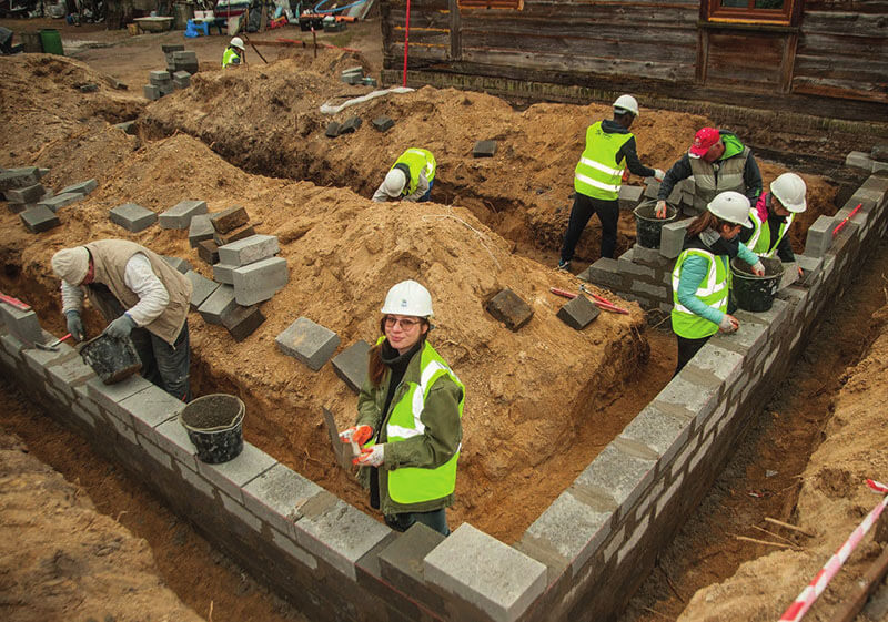 Volunteers in europe on construction site building homes