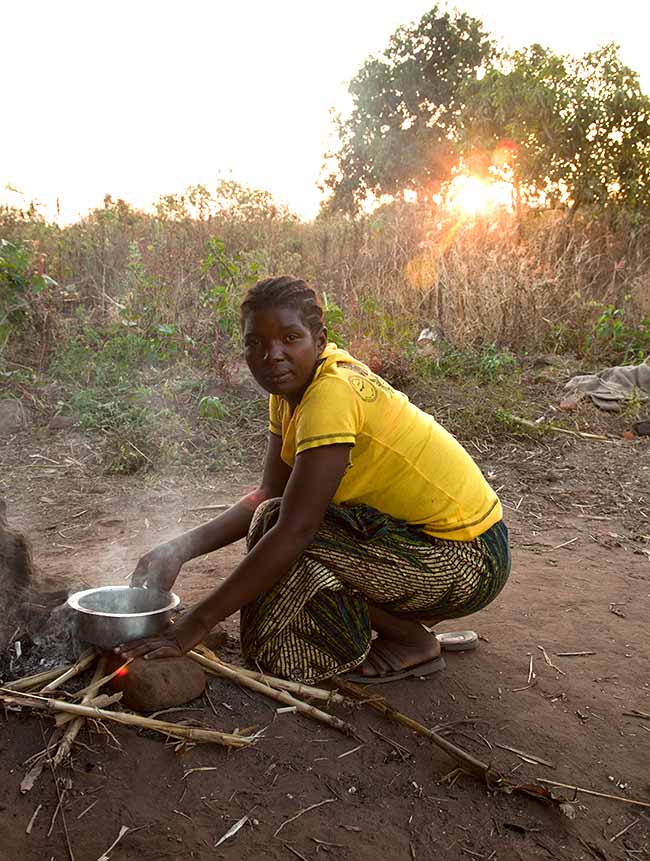 Vulnerable children in Malawi needing new homes - cooking outside