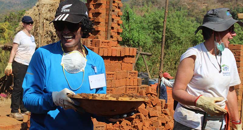 Women volunteers build homes in India