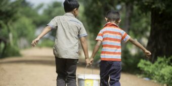 MKAK VILLAGE, Cambodia (7-24-2014) Ð Two young boys carry water from new wells that the community shares in Mkak Village. Since 2007, Habitat Cambodia has been working in Mkak Village and the district of Angkor Chum, providing water, sanitation and hygiene. Photo courtesy of Habitat for Humanity Australia