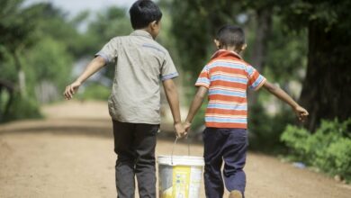 MKAK VILLAGE, Cambodia (7-24-2014) Ð Two young boys carry water from new wells that the community shares in Mkak Village. Since 2007, Habitat Cambodia has been working in Mkak Village and the district of Angkor Chum, providing water, sanitation and hygiene. Photo courtesy of Habitat for Humanity Australia