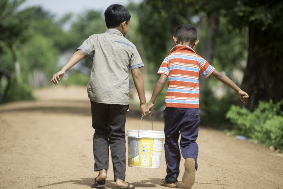 MKAK VILLAGE, Cambodia (7-24-2014) Ð Two young boys carry water from new wells that the community shares in Mkak Village. Since 2007, Habitat Cambodia has been working in Mkak Village and the district of Angkor Chum, providing water, sanitation and hygiene. Photo courtesy of Habitat for Humanity Australia