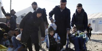 Tagrid Naif with her son Leis and daughter Shadia wait for new documents