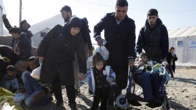 Tagrid Naif with her son Leis and daughter Shadia wait for new documents