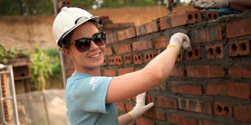 international volunteer trip laying bricks