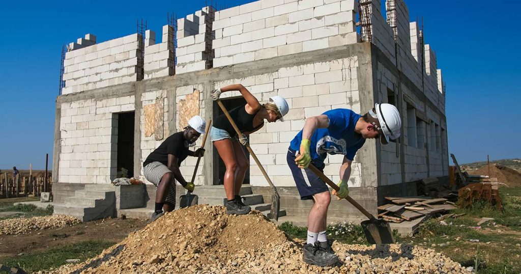 volunteers building social housing romania