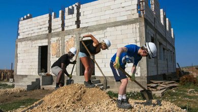 volunteers building social housing romania