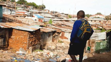 boy walking through slums