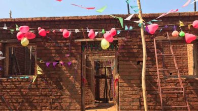 women build, finished home, India.