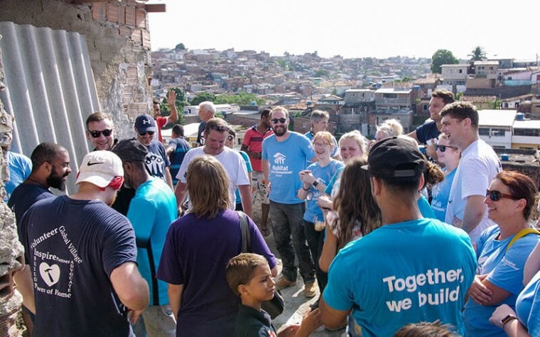 volunteers celebrate during the house building ceremony