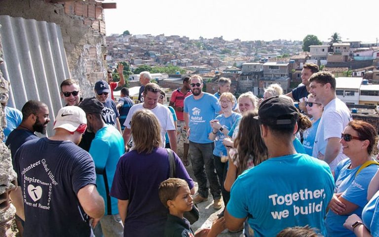 volunteers celebrate during the house building ceremony