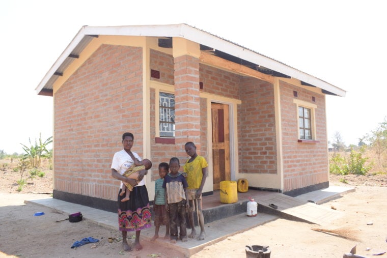 Ethel in front of new home in Malawi