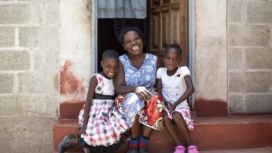 Beauty and her children smile as now they have a home of their own