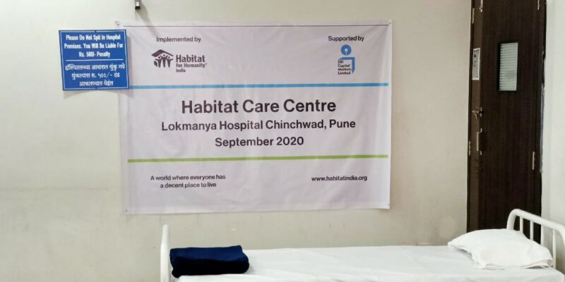 Covid 19 response by Habitat for Humanity Great Britain - a poster hangs on the wall with information about the centre