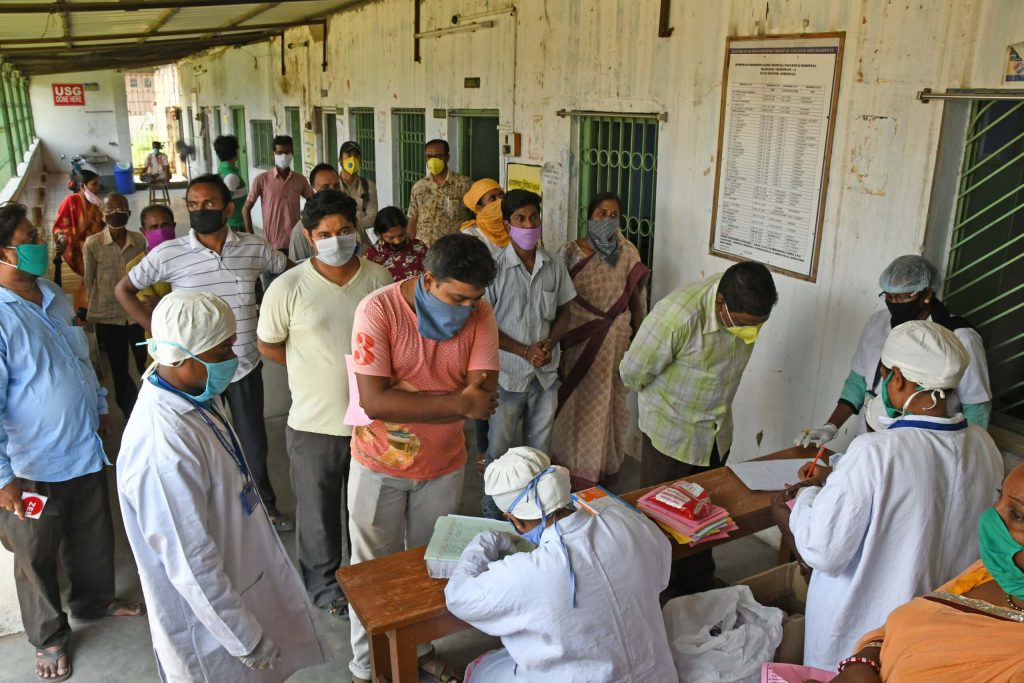 people gathering to receive medical support - Covid 19 response by Habitat for Humanity Great Britain