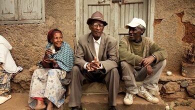 in the slums of Ethiopia a man sits with his friends