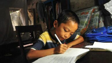 a BOY WRITES HIS HOMEWORK IN HIS NEW HOUSE