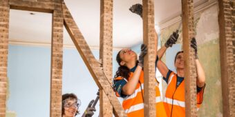 three women build at a veterans house on a Habitat for Humanity Great Britain project