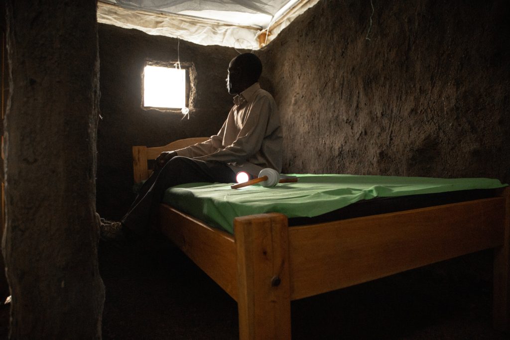 KISUMU, KENYA-MARCH 15, 2022: Identifying Housing Design Solutions That Prevent The Entry Of Mosquitoes Into Homes. Caleb Odoyo is seated inside a model hut in a controlled environment at Center of Global Health Research (KEMRI) in Kisumu Kenya. The Terwiliger Center for Innovation in Shelter provides resources in Kisumu, Kenya aimed at helping to identify housing design solutions that prevent the entry of mosquitoes into homes.