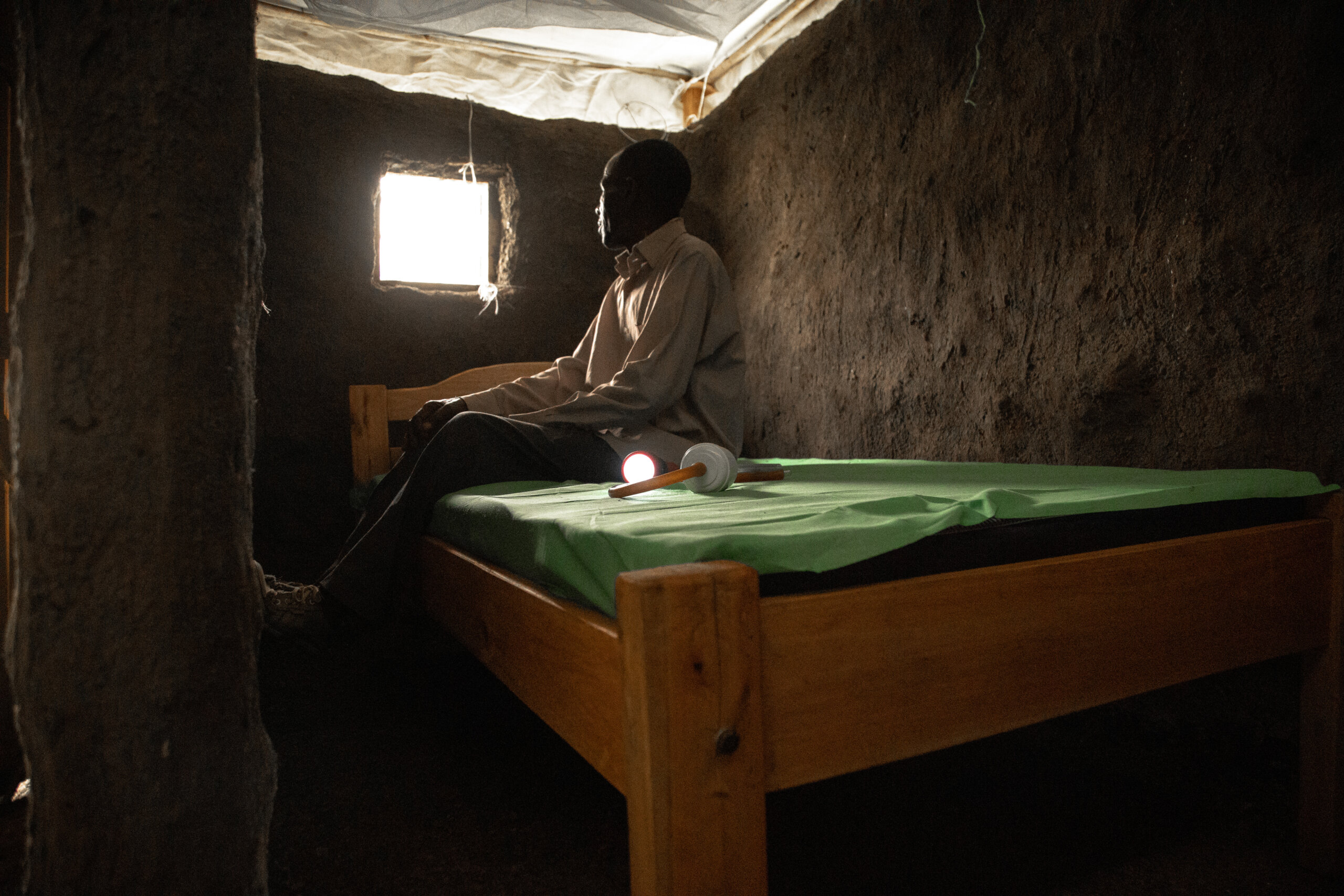 KISUMU, KENYA-MARCH 15, 2022: Identifying Housing Design Solutions That Prevent The Entry Of Mosquitoes Into Homes. Caleb Odoyo is seated inside a model hut in a controlled environment at Center of Global Health Research (KEMRI) in Kisumu Kenya. The Terwiliger Center for Innovation in Shelter provides resources in Kisumu, Kenya aimed at helping to identify housing design solutions that prevent the entry of mosquitoes into homes.