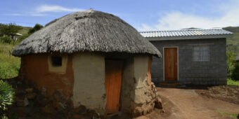 traditional hut and new house in Lesotho