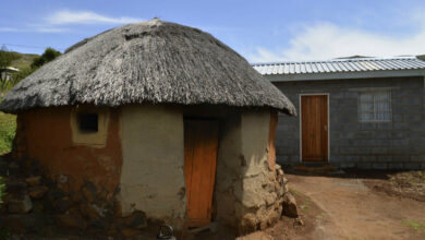 traditional hut and new house in Lesotho