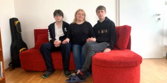 (Budapest, Hungary)- Valentina (center) and her teenaged sons Vitalik (left) and Vladik in their temporary apartment in Hungary’s capital, Budapest, on May 4, 2022. They came from Khmelnitskiy city in western Ukraine and crossed the Ukrainian-Hungarian border in early March 2022. In the first couple of weeks, they stayed in a workers’ hostel in Miskolc city in northeastern Hungary. Later they found mid-term accommodation in Budapest through a joint program by Habitat for Humanity Hungary, From Streets to Homes Association and The City is for All. Valentina and her sons moved into the temporary apartment in April 2022 and could stay in it until the end of June. Habitat for Humanity Hungary/ Zsoka Molnar