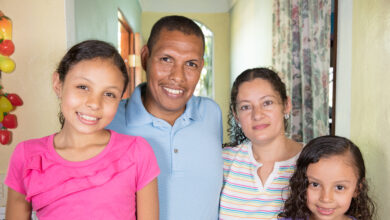 Jose and his family who were supported by Habitat for Humanity smile for the camera