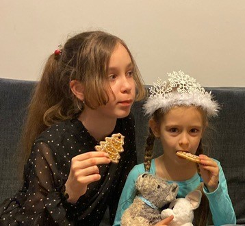 Kristina and her sister Alisa eat Christmas cookies