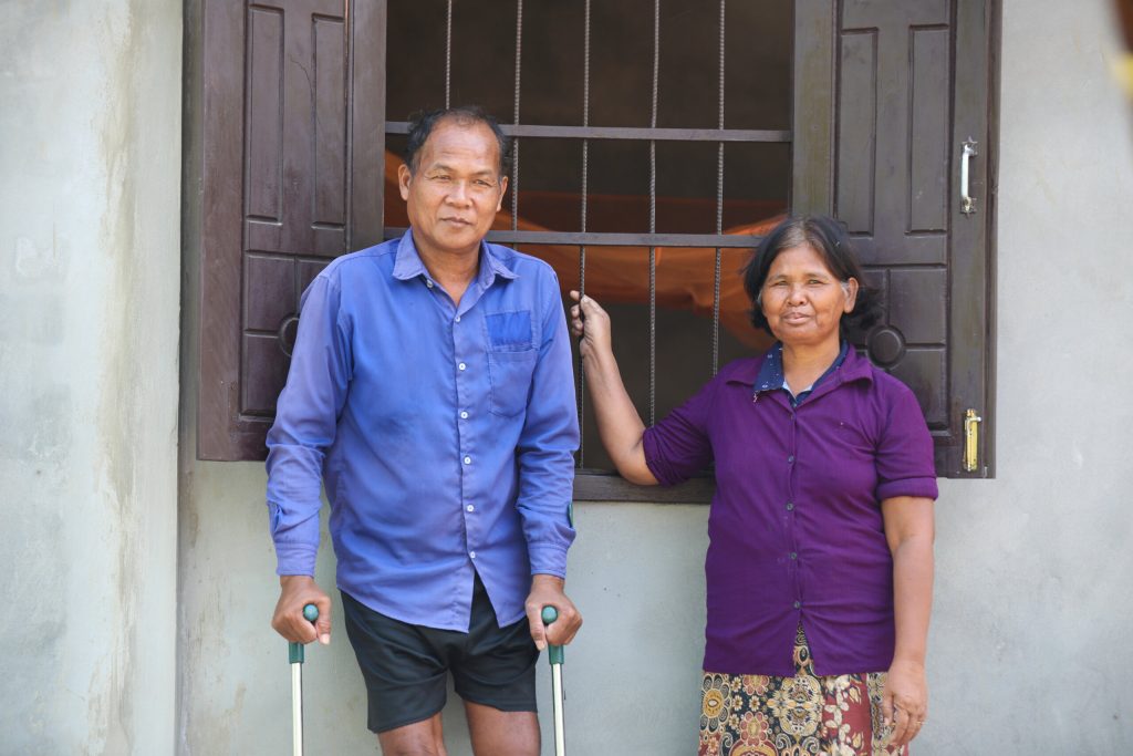 Growing Homes Together - Tat and Khon stand outside their new home