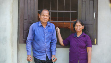 Growing Homes Together - Tat and Khon stand outside their new home