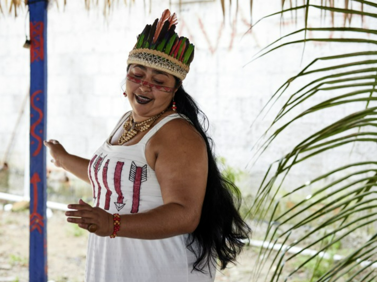 indigenous woman dances in Brazil - home equals