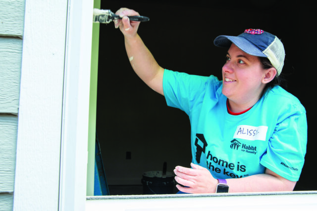 Person with a paintbrush, painting a windowpane