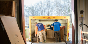 Two ReStore staff loading a delivery truck