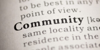 Close-up of a dictionary page with the word 'community' highlighted