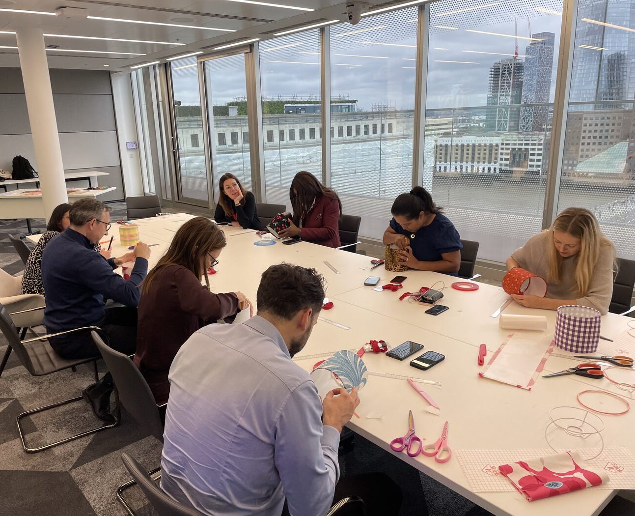 Volunteers making lampshades at a Habitat for Humanity workshop