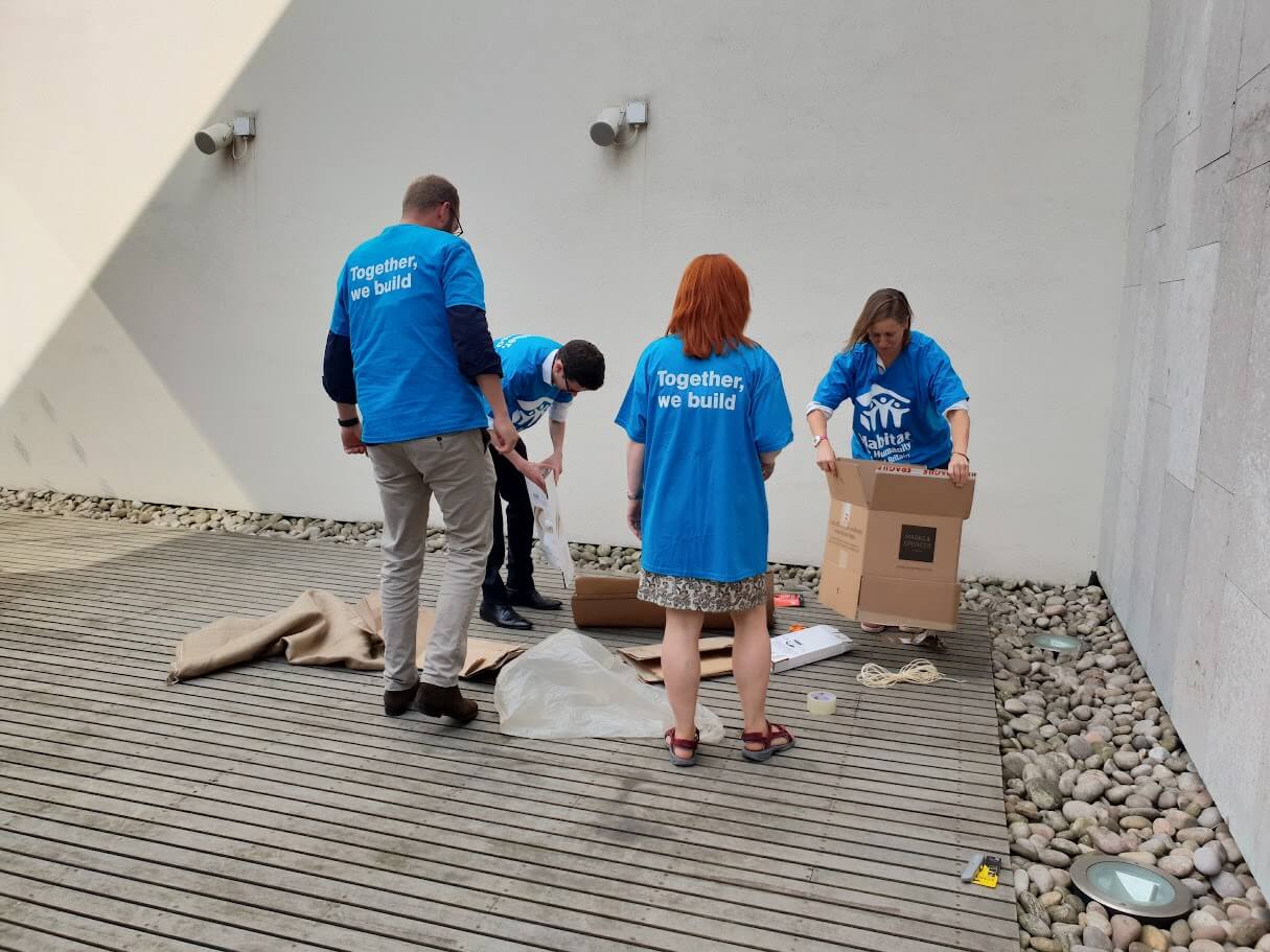 Four people unpacking boxes together