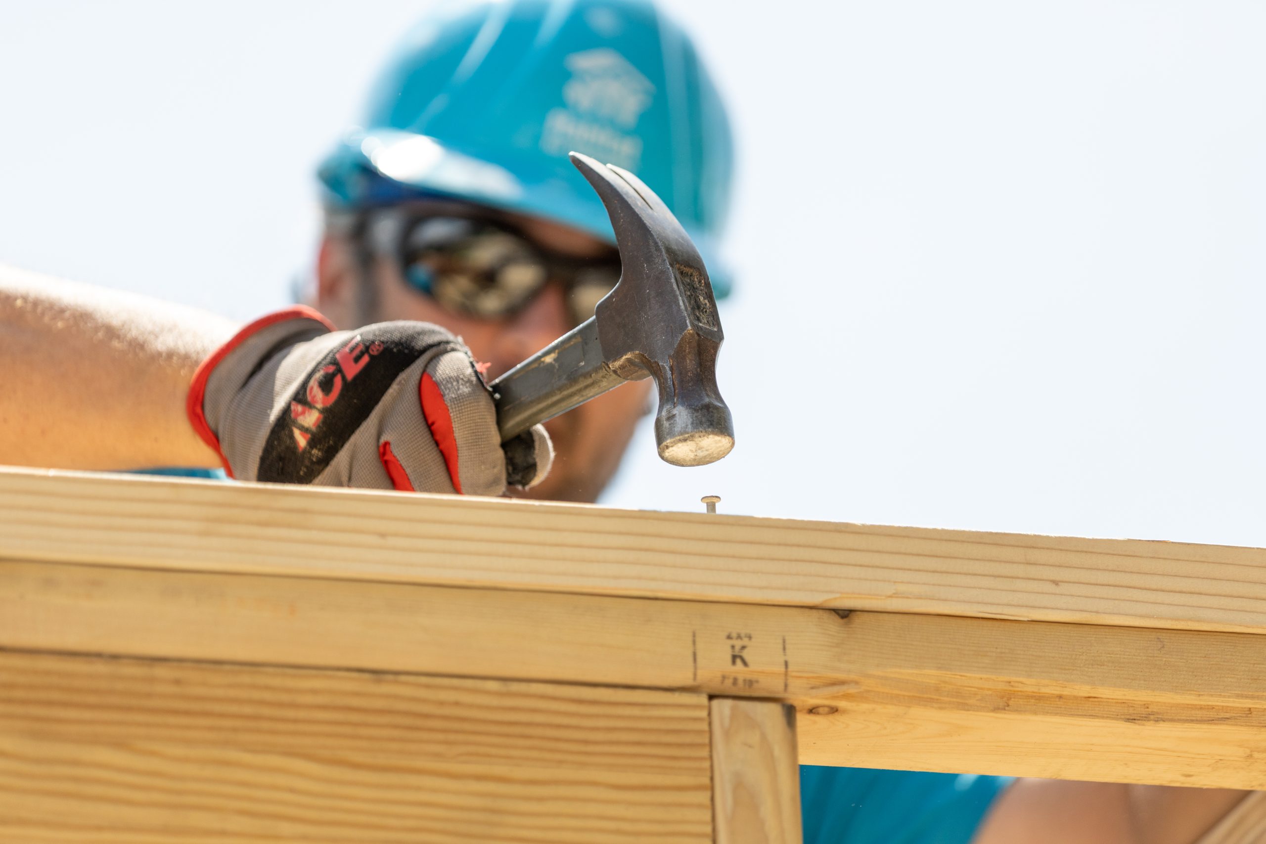 A volunteer in a helmet and goggles working outdoors