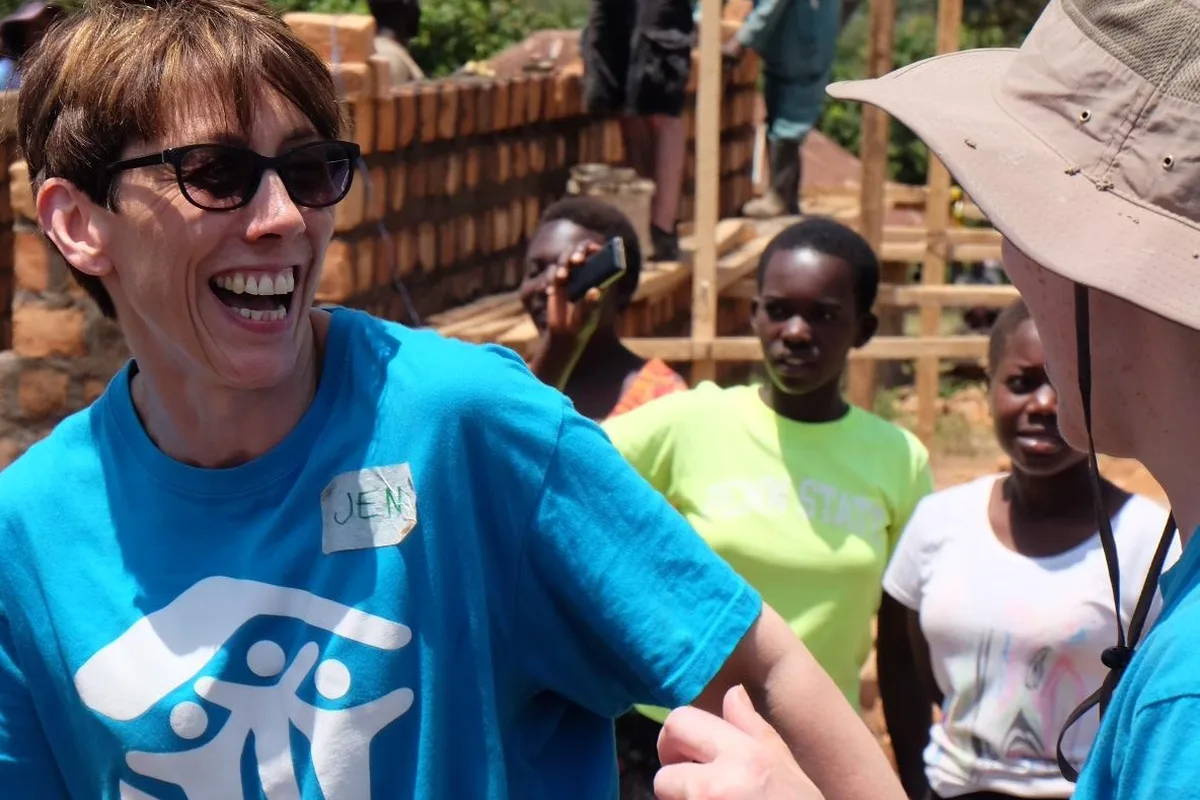 Volunteers and a family building a home together with Habitat for Humanity