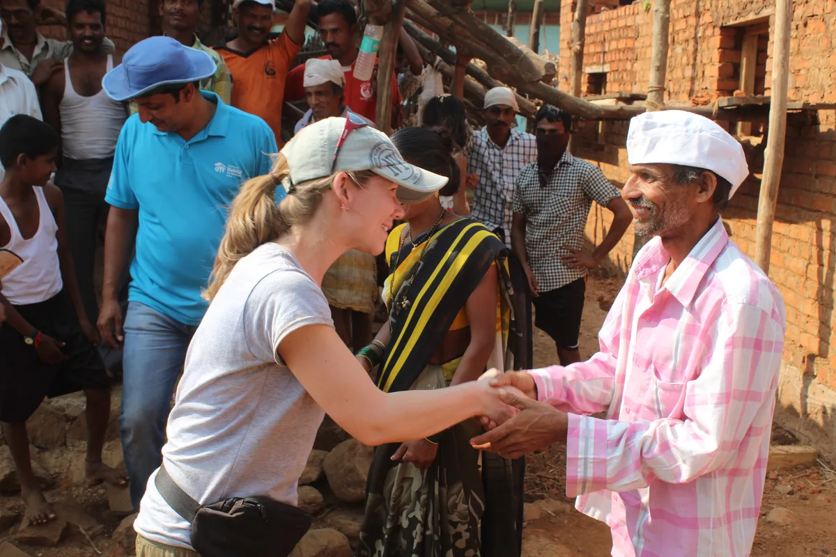 Two people shaking hands at a Habitat build