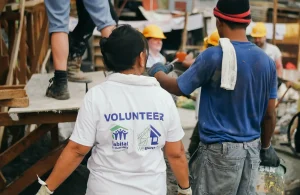 Two people working on a Habitat building project