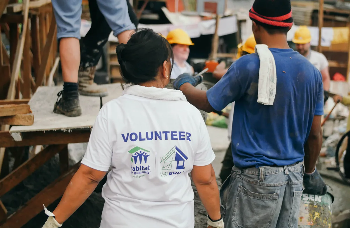Two people working on a Habitat building project