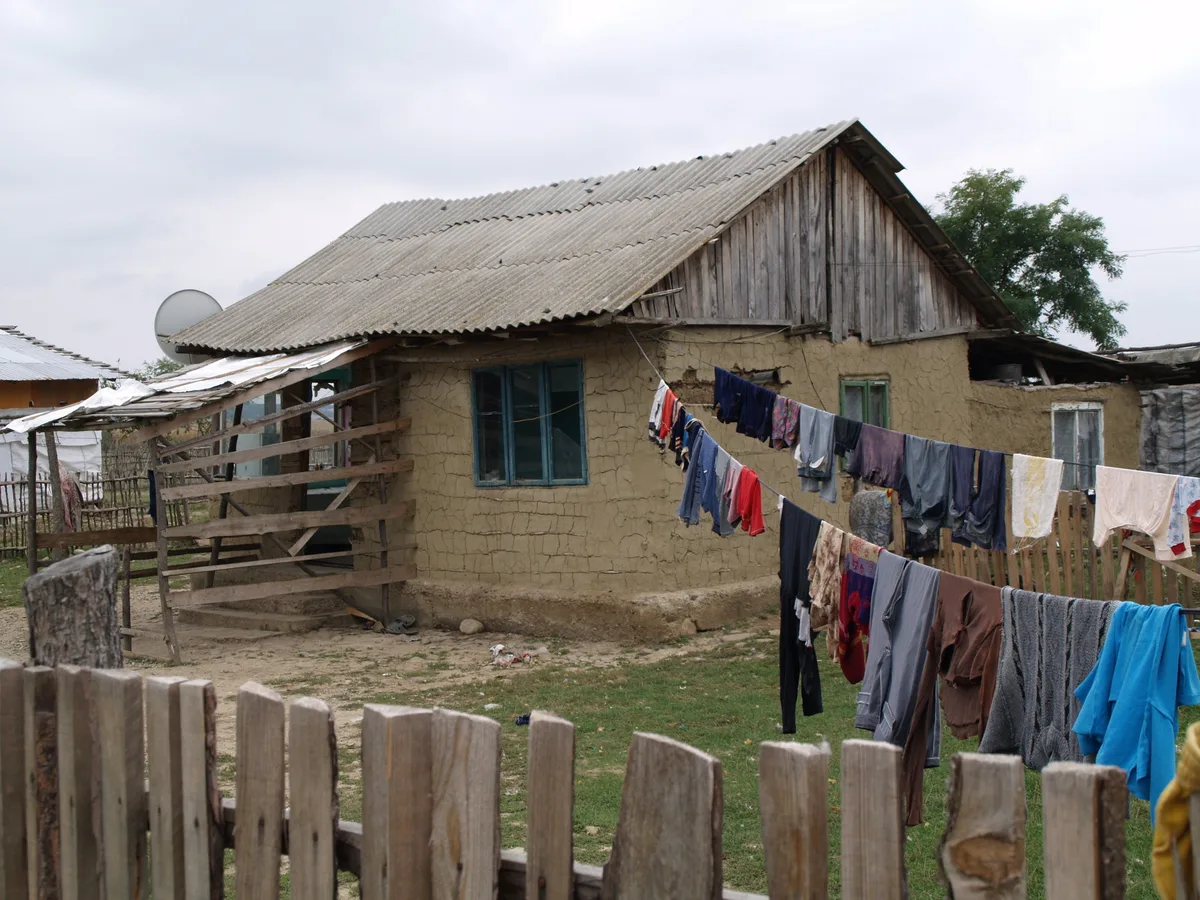 A rural home with laundry hanging on a line outside